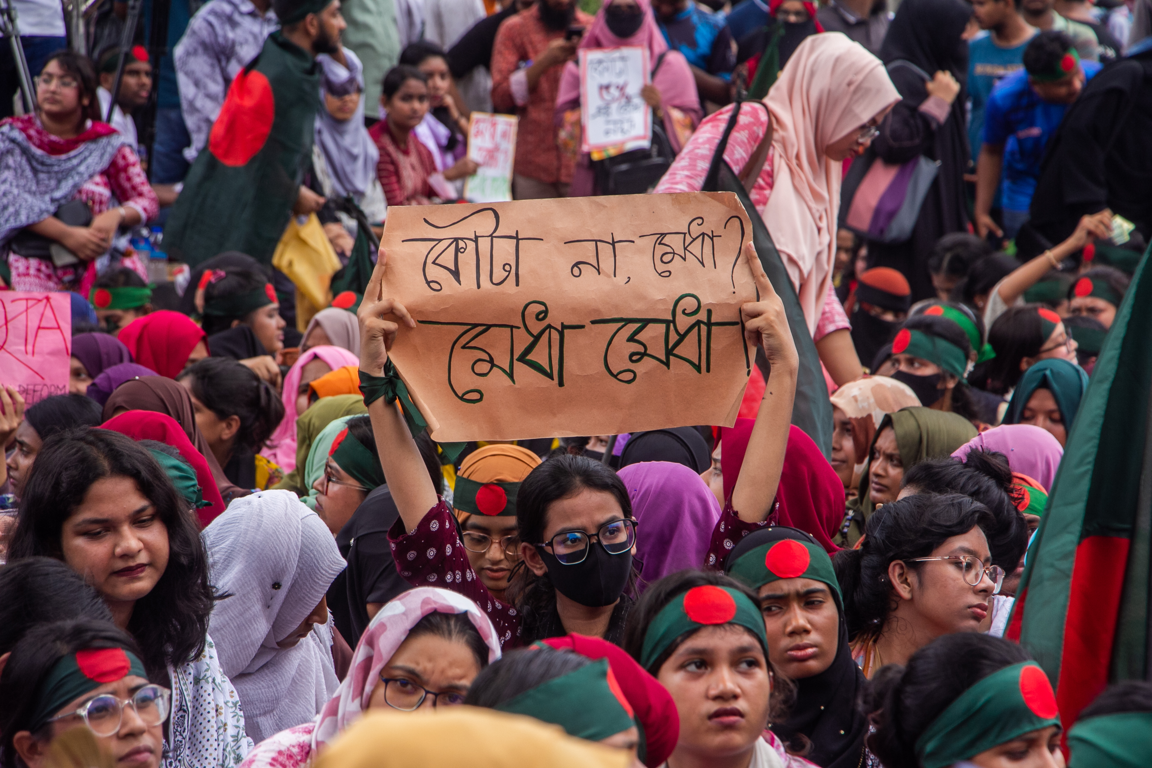 Quota reform protest in Bangladesh with a sign reading "Not quotas, merit!" (photo credit: Rayhan9d via Wikimedia Commons) Quota reform protest in Bangladesh with a sign reading "Not quotas, merit!" (photo credit: Rayhan9d via Wikimedia Commons)